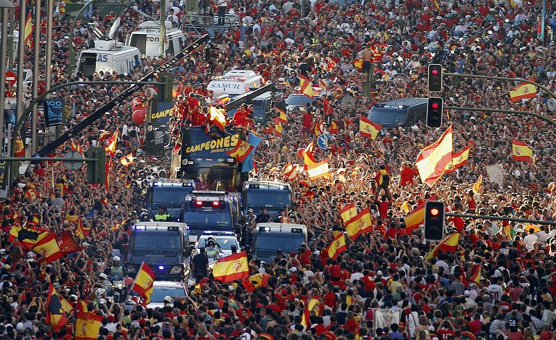Crowds gather around the Spain's national soccer team during a celebration parade in downtown Madrid