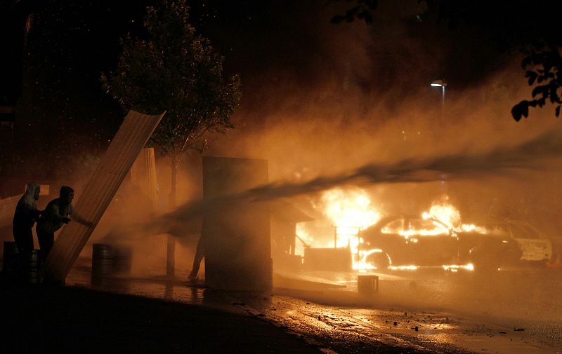 La policía norirlandesa intenta extinguir el fuego provocado por los jóvenes nacionalistas católicos