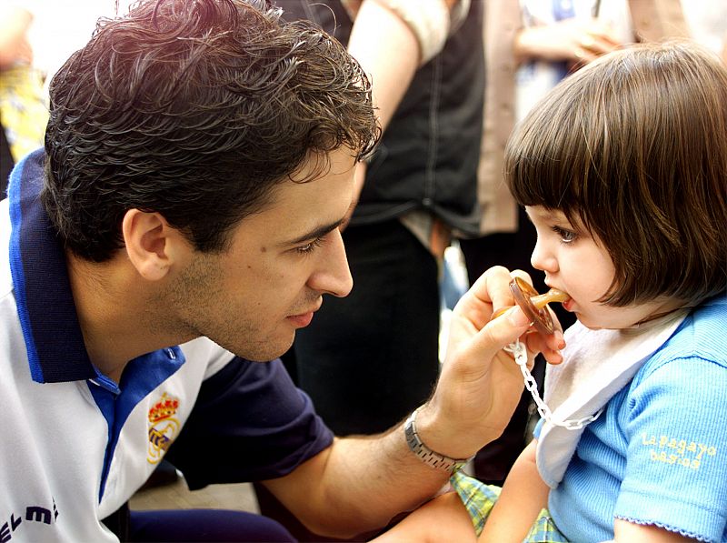 Real Madrid's striker Raul Gonzalez puts a dummy in the mouth of the team's goalie's daughter Carlot..