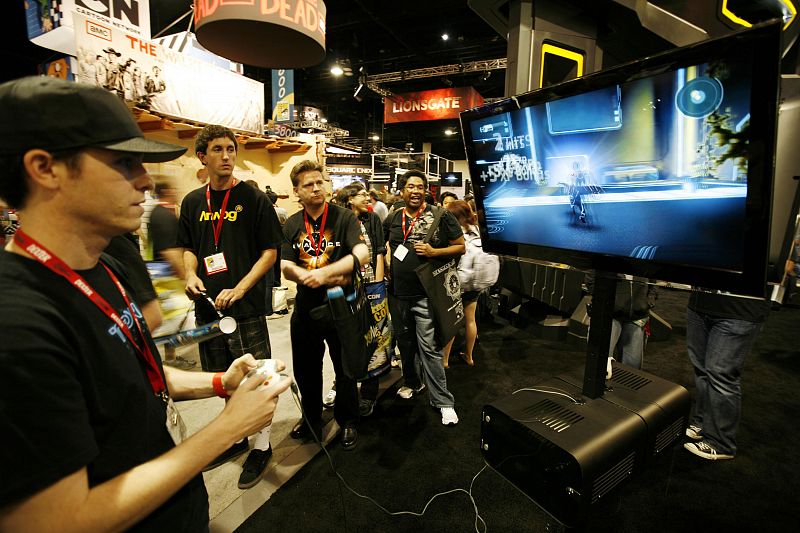 An attendee tries out a new video game based on Disney's movie "Tron" during the opening night of annual Comic Con convention in San Diego