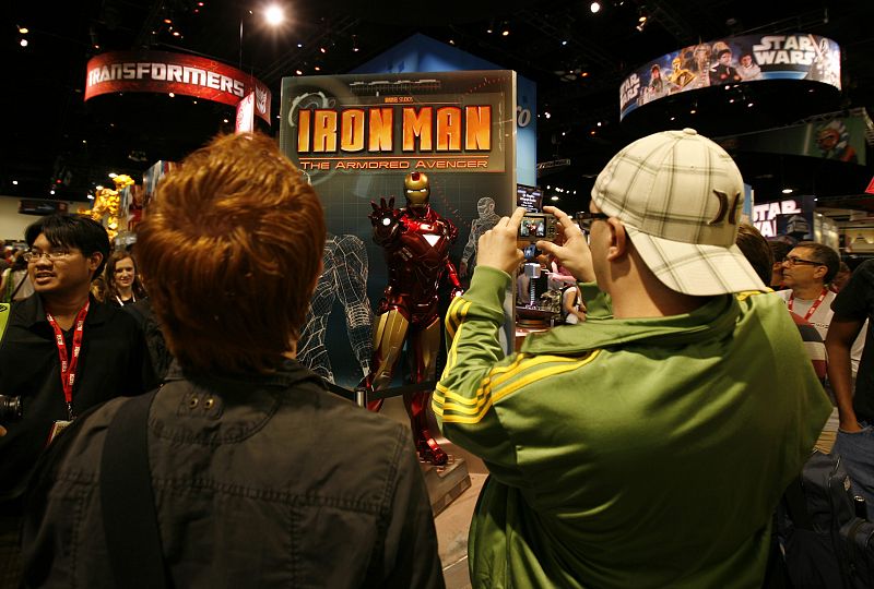 Attendees take photographs of a life size statue of Iron Man while on the convention floor during the opening night of the annual Comic Con in San Diego