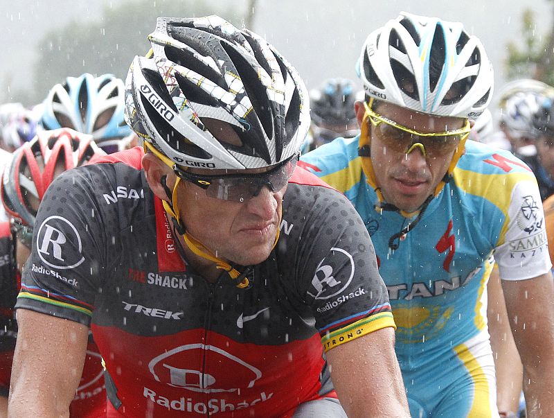 Radioshack's Lance Armstrong of the U.S and Astana's Alberto Contador of Spain ride in the rain during the second stage of the Tour de France cycling race from Brussels to Spa