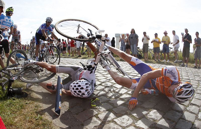 Riders fall on the cobblestones during the third stage of the Tour de France cycling race between Wanze and Arenberg-Porte Du Hainaut