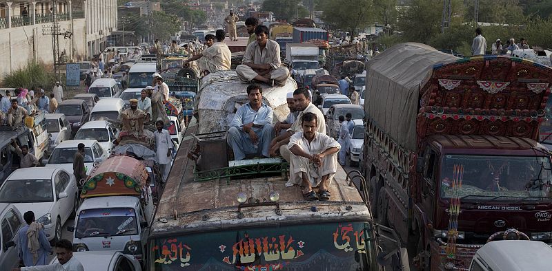 Passengers and cargo trucks are grid-locked for miles after townsmen blocked the roads to traffic until relief supplies were distributed to flood victims in Nowshera