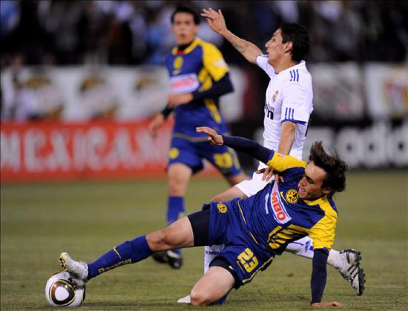 El jugador mexicano del América Joaquín Martínez intenta esquivar al argentino del Real Madrid Ángel Di María durante el partido amistoso disputado entre ambos equipos en el Candlestick Park de San Francisco, California. El equipo español venció po