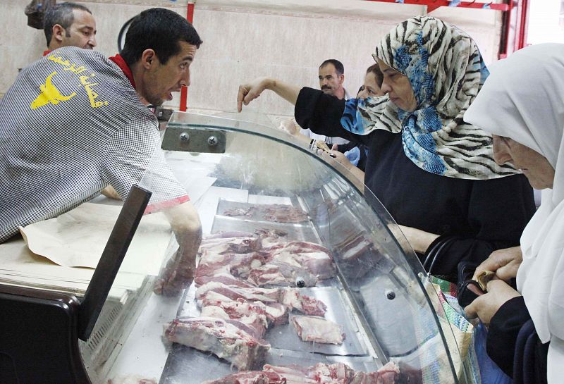 An Algerian woman buys meat on the first day of Ramadan in downtown Algiers