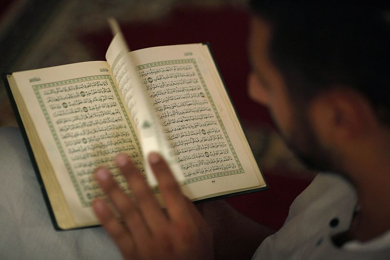 A Muslim man reads the Koran on the first day of Ramadan at a mosque in the southern Spanish town of Estepona