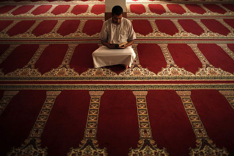 A Muslim man reads the Koran during the first day of Ramadan at a mosque in Estepona