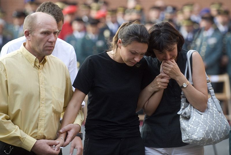 Family members of two Spanish civil guards who were killed in Afghanistan grieve during their funeral in Logrono