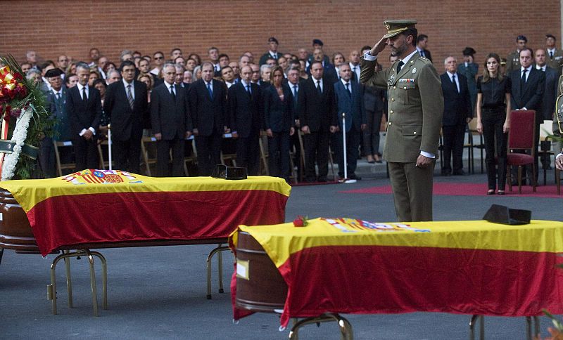 Spain's Crown Prince Felipe salutes the coffins of two Spanish civil guards who were killed in Afghanistan during their funeral in Logrono