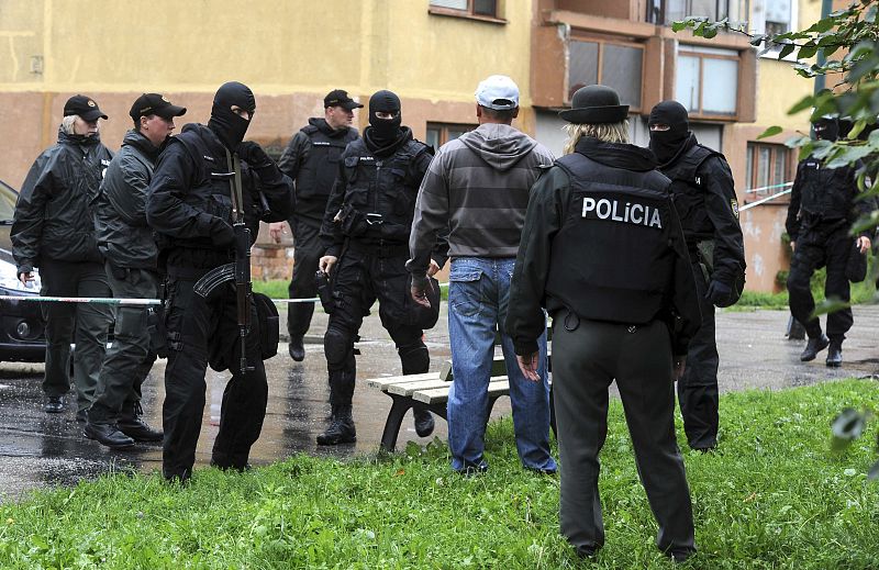 Police speak to the brother of a shooting victim in the Devinska Nova Ves district of Bratislava