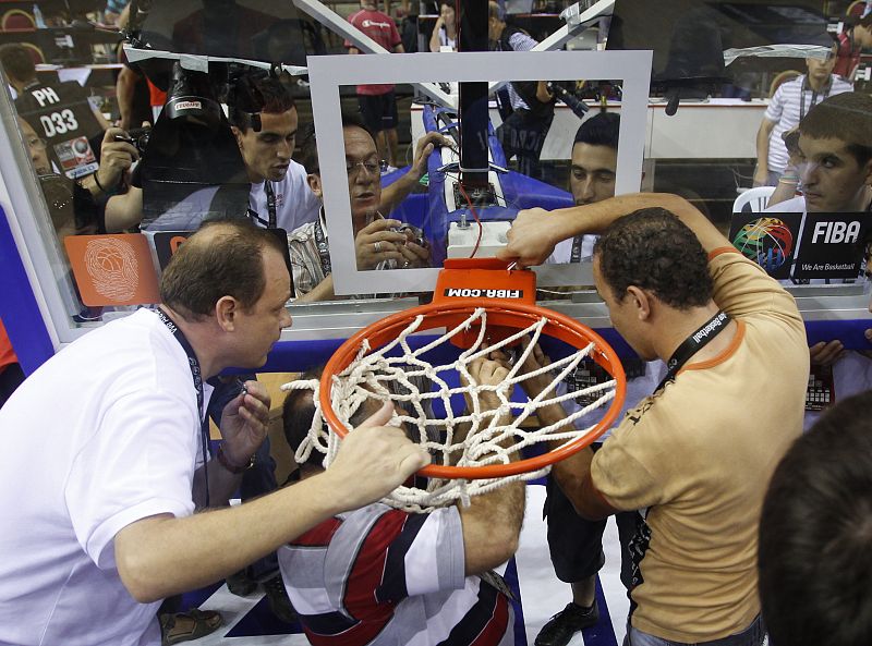 Officials work to replace basket after it was broken during FIBA Basketball World Championship game between France and Lebanon in Izmir