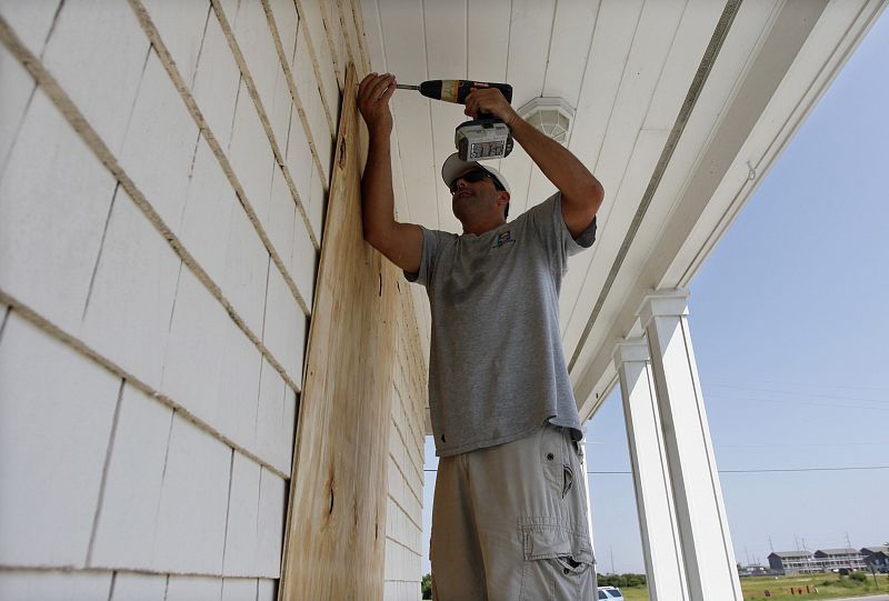 Worker boards up windows at a building during the approach of Hurricane Earl in Buxton on Cape Hatteras, North Carolina