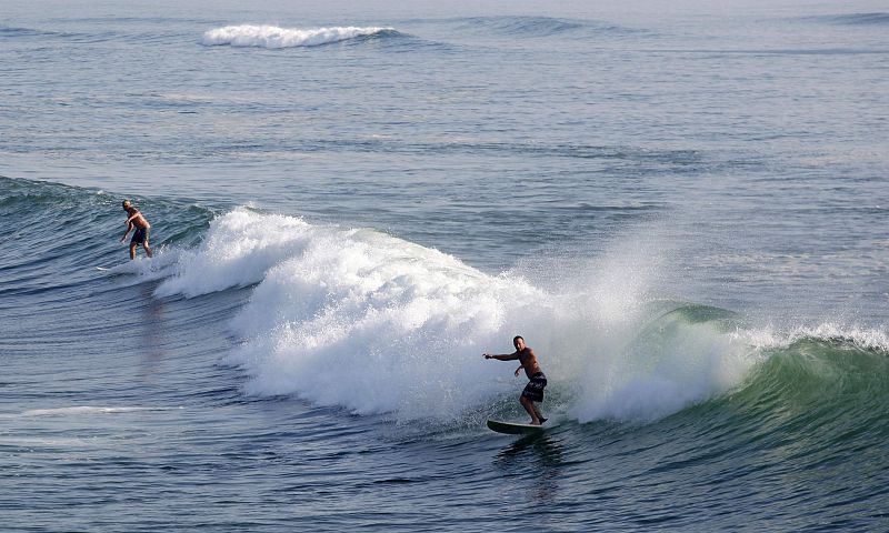 Surfers take advantage of rising swells during the approach of Hurricane Earl near Rodanthe on Cape Hatteras