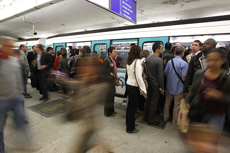 Commuters crowd into the metro at the Gare Saint Lazare metro station in Paris