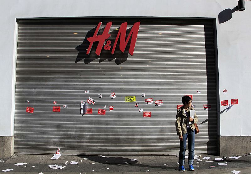 Una mujer, frente a una tienda cerrada en el centro de Madrid, donde los piquetes han sido bastante violentos.