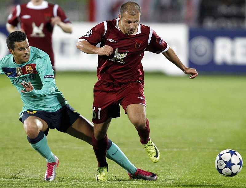 Rubin Kazan's Karadeniz challenges Barcelona's Pedro during their Champions League Group D soccer match at Central stadium in Kazan