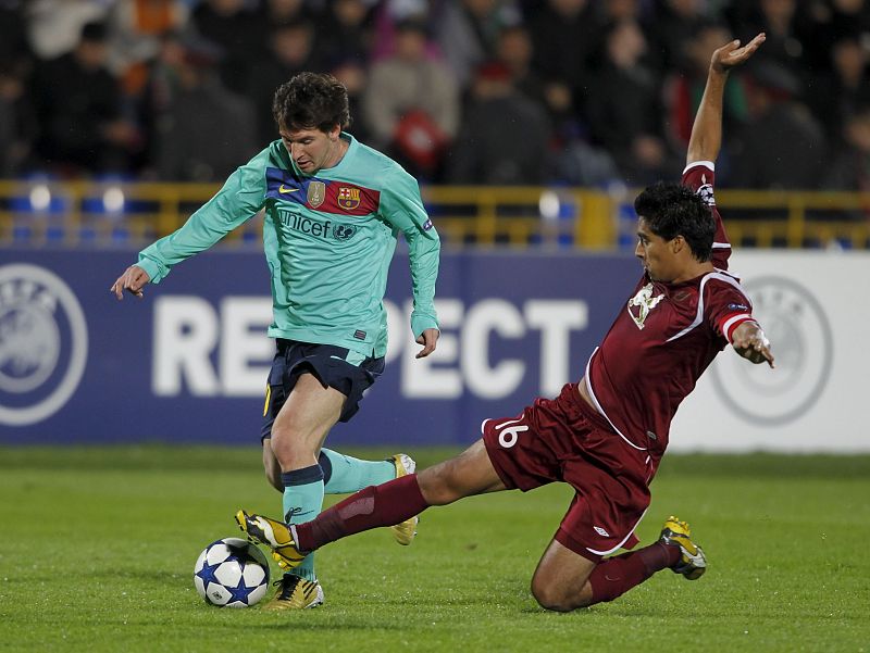 Christian Noboa, autor del gol del Rubin, pelea por el balón con el argentino del Barça Leo Messi.