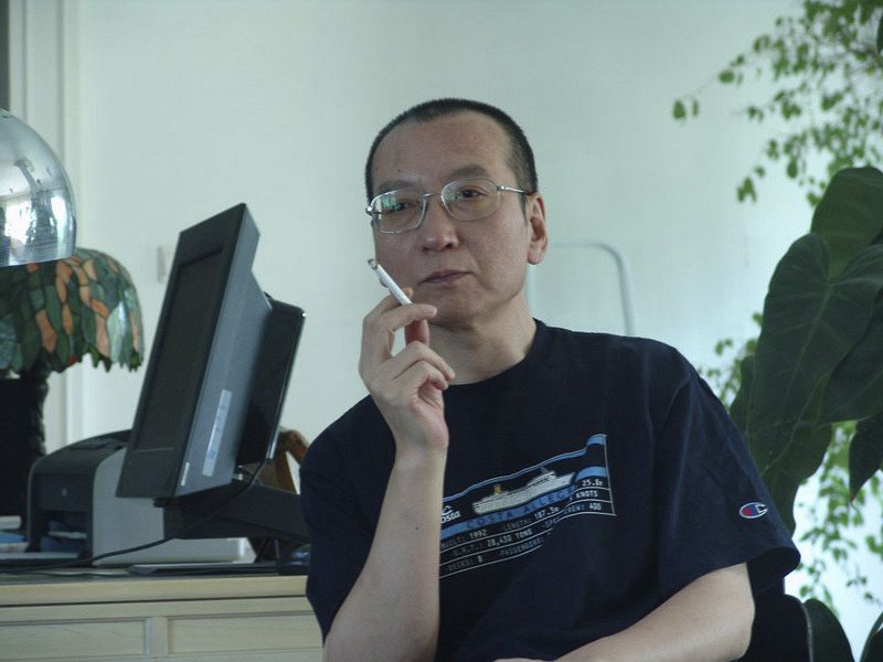 Chinese dissident Liu Xiaobo smokes a cigarette in this undated photo released by his family