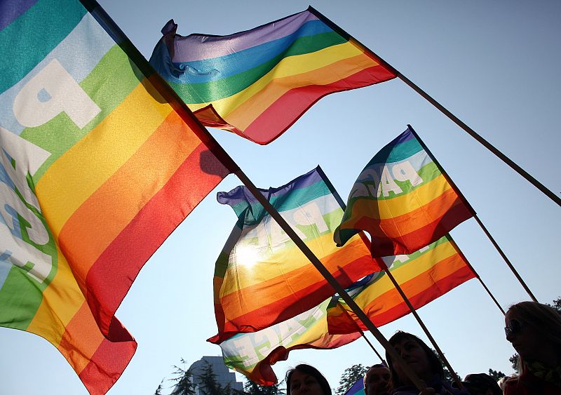 Gay rights activists wave flags during a rally in Belgrade