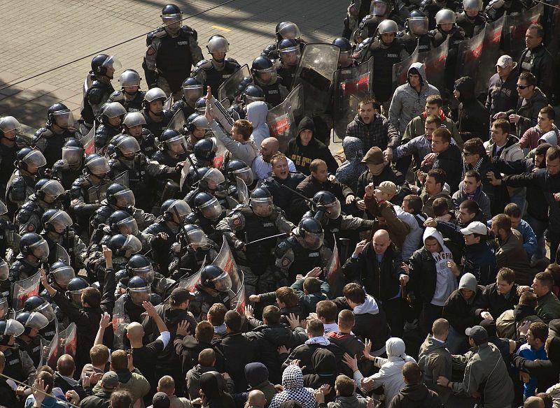 Anti-gay protesters clash with riot policemen during riots in Belgrade