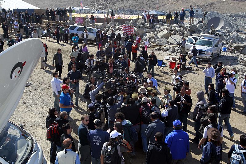 Members of the media gather as rescued Chilean miner Daniel Herrera arrives at the San Jose mine in Copiapo