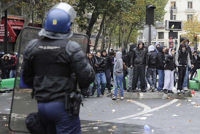 French high school students face riot gendarmes during a student demonstration at Place de la Republique in Paris