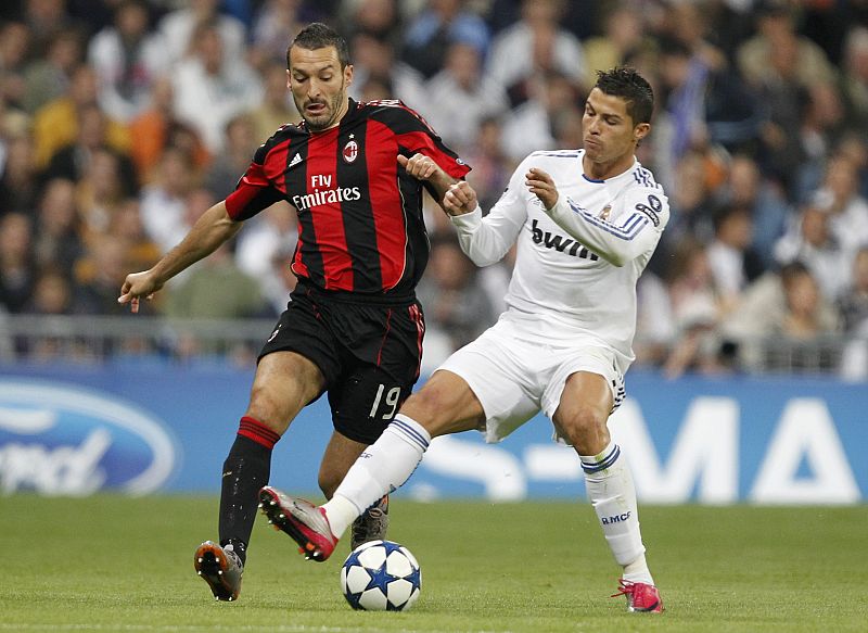 Real Madrid's Cristiano Ronaldo and AC Milan's Zambrotta fight for the ball during their Champions League Group G soccer match in Madrid