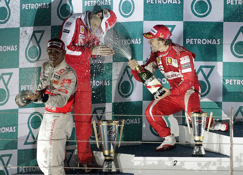 Ferrari Formula One driver Alonso, team mate Massa and McLaren driver Lewis Hamilton spray champagne as they celebrate on the podium after Alonso won the South Korean F1 Grand Prix at the Korea International Circuit in Yeongam