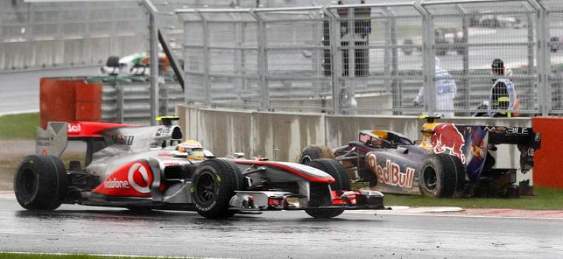 McLaren Formula One driver Hamilton of Britain drives past the crashed car of Red Bull Formula One driver Webber of Australia during the South Korean F1 Grand Prix at the Korea International Circuit in Yeongam