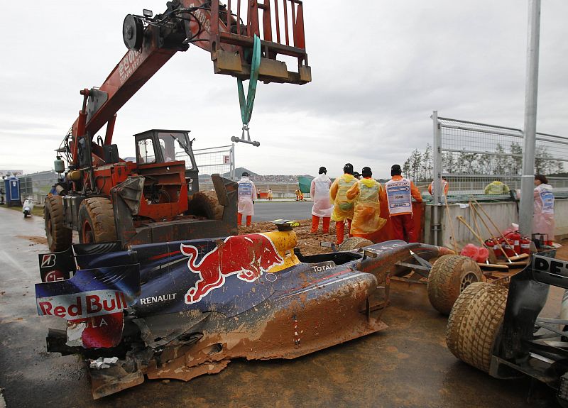 A crane moves in to recover the car of Red Bull Formula One driver Webber of Australia after he crashed out of the South Korean F1 Grand Prix at the Korea International Circuit in Yeongam