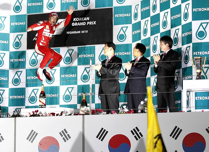 Ferrari Formula One driver Alonso of Spain jumps as he celebrates on the podium after winning the South Korean F1 Grand Prix at the Korea International Circuit in Yeongam