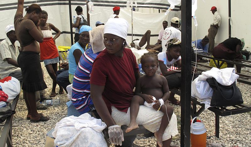 Haitians suffering from cholera wait for medical treatment with their relatives at a local hospital in the town of Saint Marc