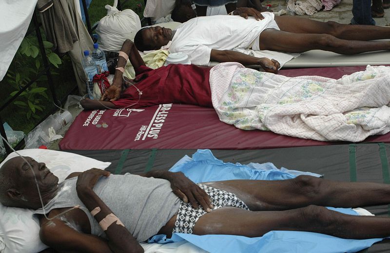 Haitians suffering from cholera wait for medical treatment at a local hospital in the town of Saint Marc