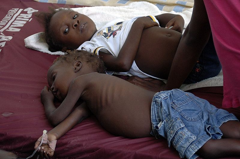 Children suffering from cholera wait for medical treatment at a local hospital in the town of Saint Marc