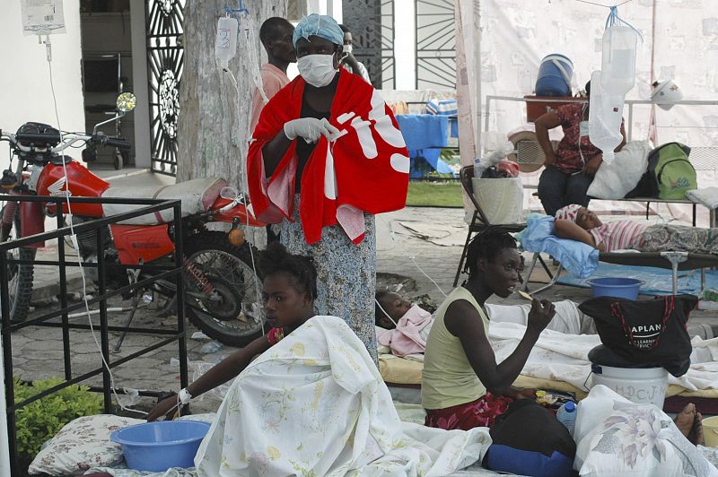 Haitians suffering from cholera wait for medical treatment at a local hospital in the town of Saint Marc