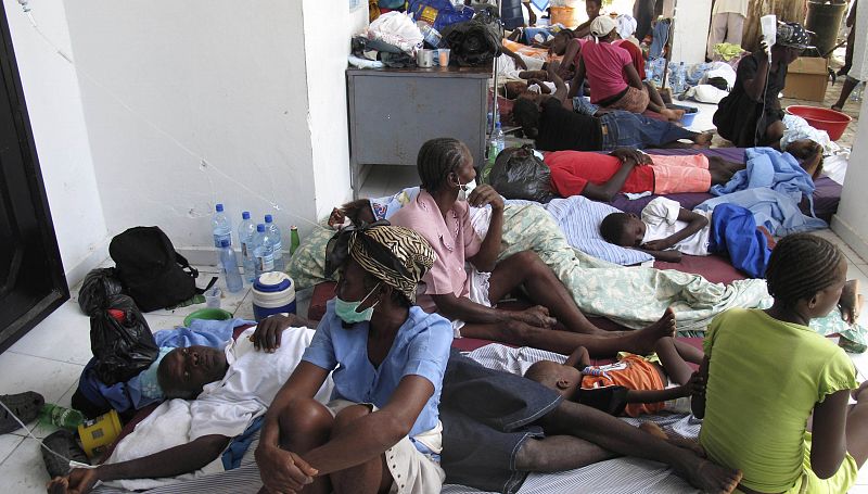 Haitians suffering from cholera wait for medical treatment with their relatives at a local hospital in the town of Saint Marc