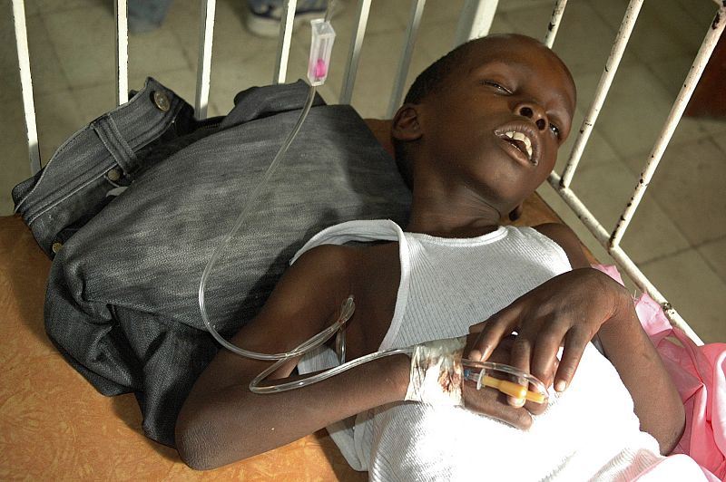 A boy suffering from cholera sleeps while waiting for medical treatment at a local hospital in the Marchand Dessaline zone