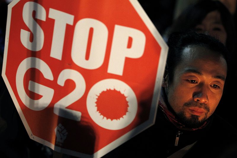 Anti-G20 protesters hold their banners as they gather in central Seoul