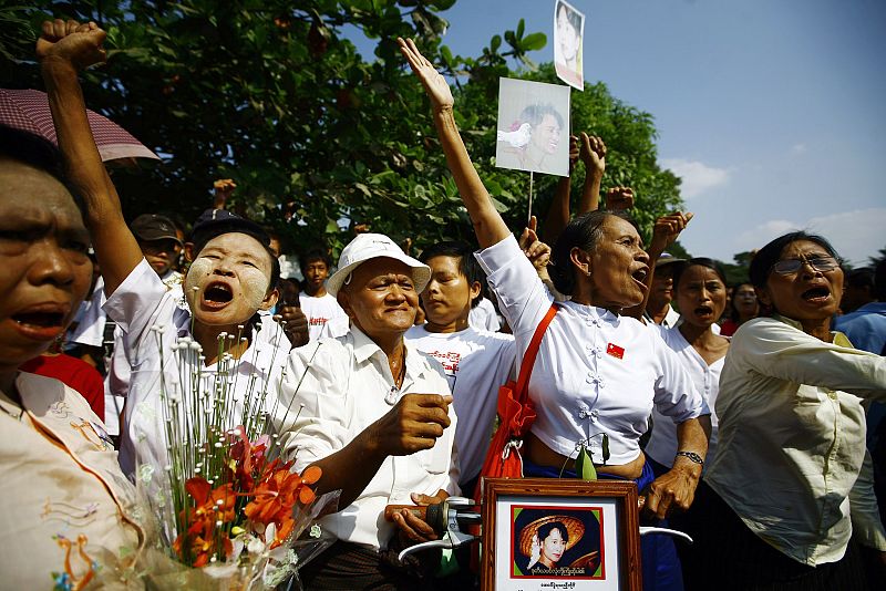 Members of the NLD party shout during a protest outside the house of their leader, Aung San Suu Kyi, in Yangon