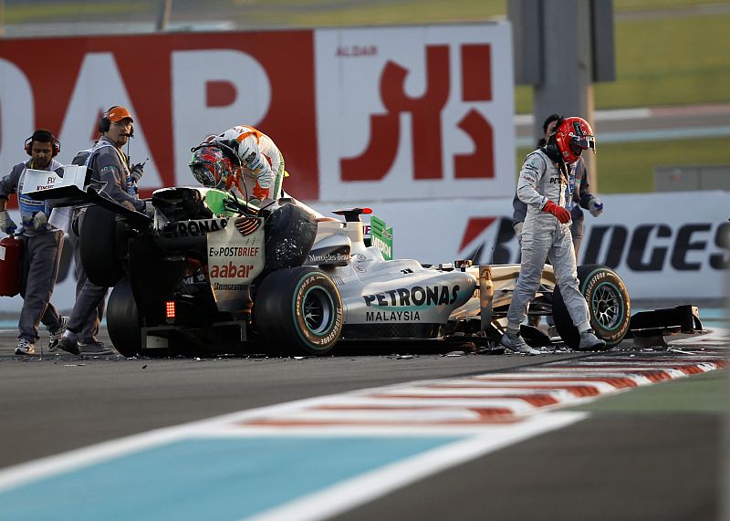 Schumacher walks away from his car after crashing with Liuzzi during the Abu Dhabi F1 Grand Prix at Yas Marina circuit in Abu Dhabi