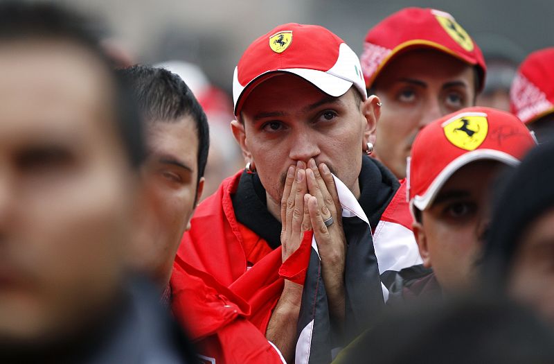 A Ferrari supporter reacts as he watches the Abu Dhabi F1 Grand Prix at Yas Marina circuit on a giant screen in Maranello