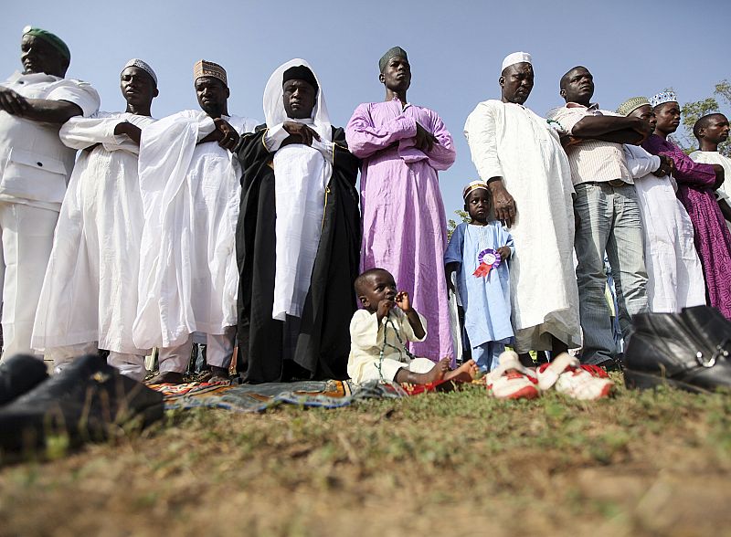 Muslims attend prayers to mark the Islamic festival of Eid el-Kebir, in an open ground in Nigeria's federal Capital Abuja