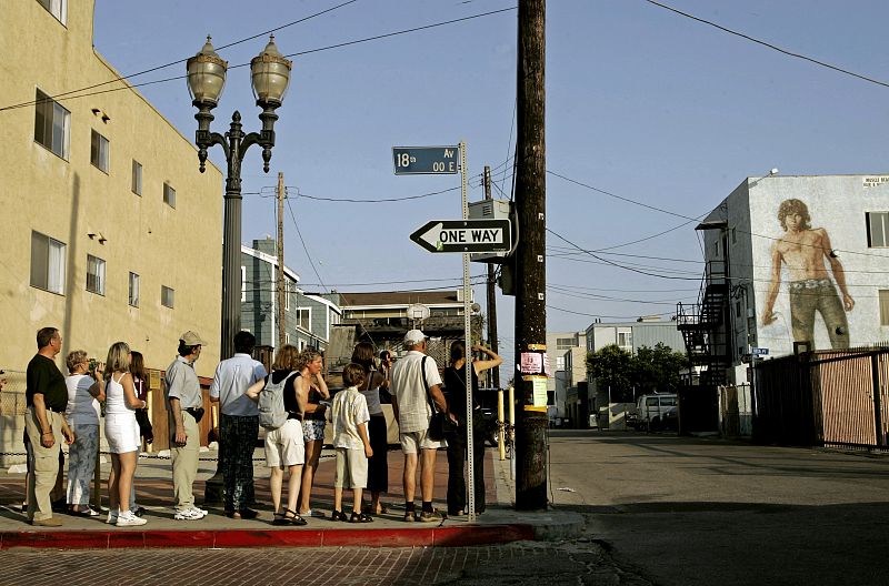 Tourists view mural of musician Jim Morrison near boardwalk as Venice Beach celebrates 100th year of ...