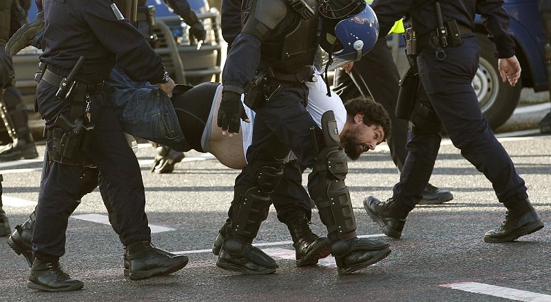 A man is removed by police during a protest against the NATO summit in Lisbon