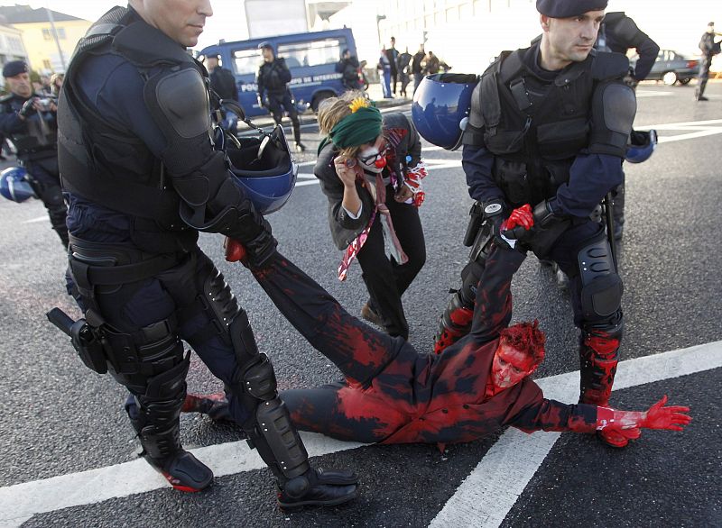 A person is removed by police during a protest against the NATO summit in Lisbon