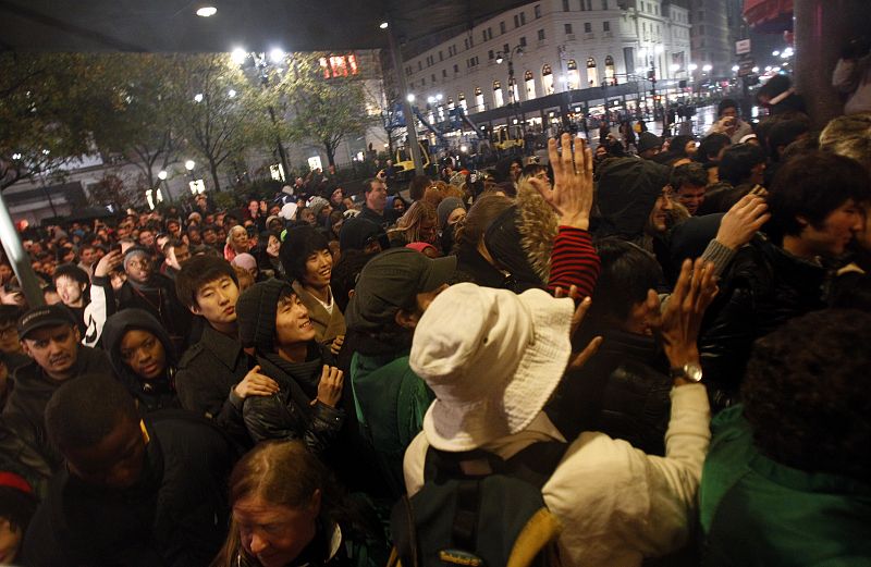 Customers surge to get inside the door as Macy's opens on Black Friday in New York