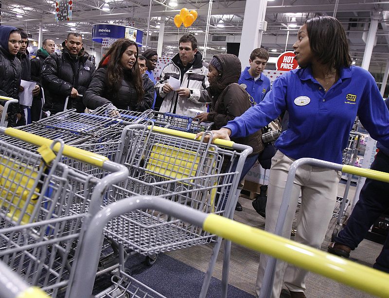 People reach for shopping carts during Black Friday sales at the Best Buy electronics store in Westbury,New York