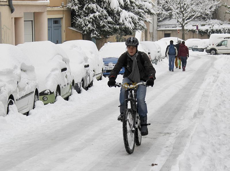 Un ciclista intenta desplazarse por las calles de Lyon (Francia)