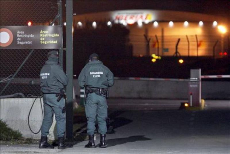 Dos guardias civiles vigilan la zona de la torre de control del aeropuerto de El Prat de Barcelona, cuyo cierre ha sido provocado por el abandono masivo de sus puestos de trabajo de los controladores.